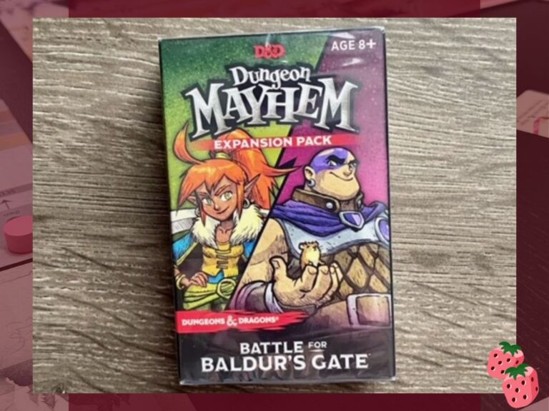 On top of a wooden surface is a package reading Dungeon Mayhem Expansion Pack, Battle for Baldur's Gate. Two humanoid fantasy creatures are pictured.