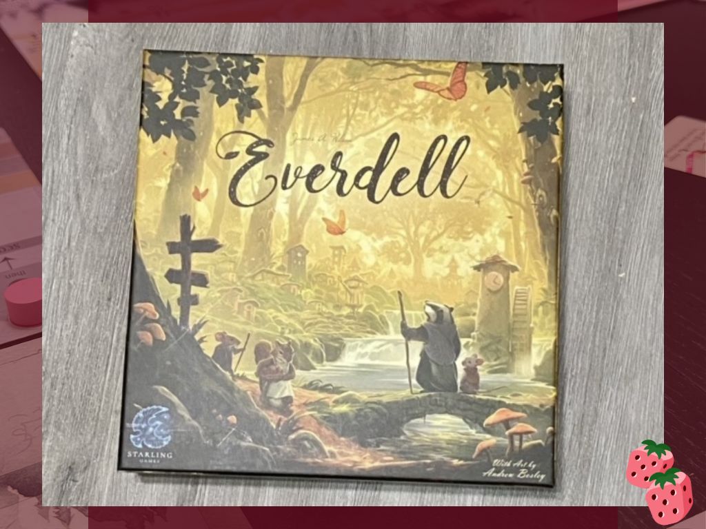 A game box pictured a scene in the woods has the word Everdell written at the top center. Also on the box is the Starling Games logo in the bottom left. A badger standing upright and a mouse are on the right hand side of the picture, looking at a small waterfall.