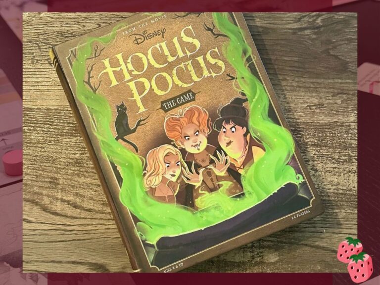 The front of the board game Hocus Pocus sits on top of a wooden surface.