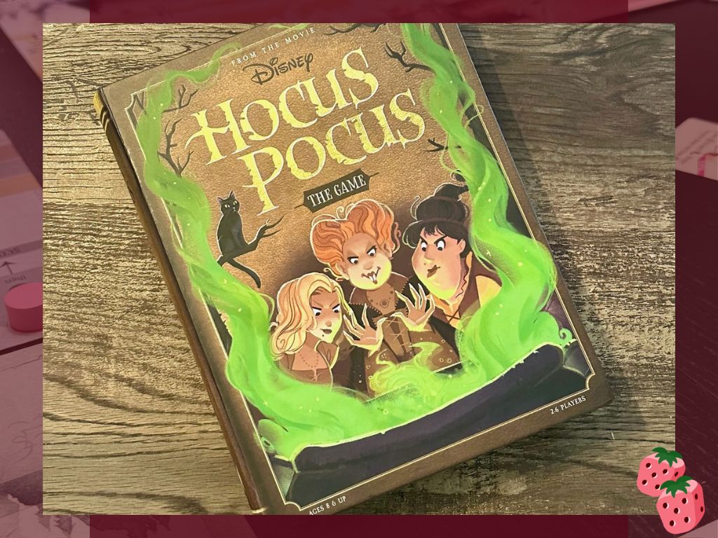 The front of the board game Hocus Pocus sits on top of a wooden surface.