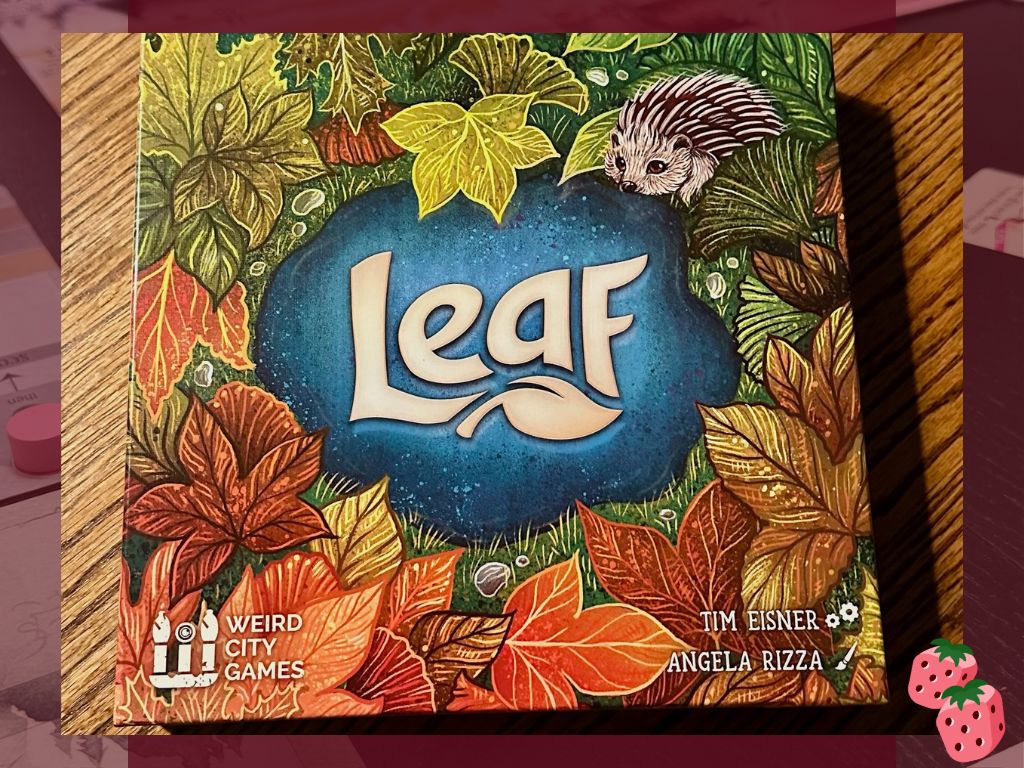 The game box for Leaf by Weird City Games sits on top of a wooden surface.