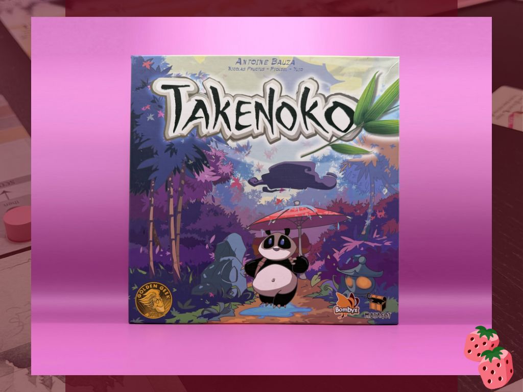 A game box reading Takenoko is pictured in the back centered of the frame. On the box you can see a Panda Bear, holding an umbrella in the rain, walking through a bamboo forest.
