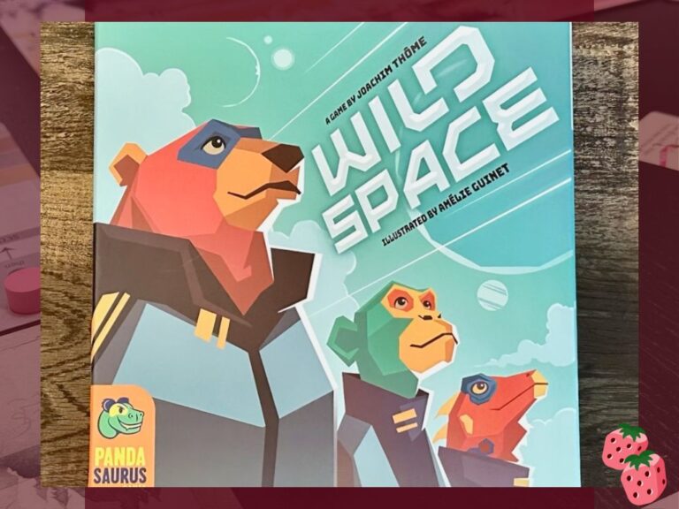 The board game cover for Wild Space is pictured on a wooden surface. The Pandasaurus logo is on the bottom left corner of the box. A bear, monkey and dragon dressed as astronauts are on the front of the box with a blue background of varying shades.