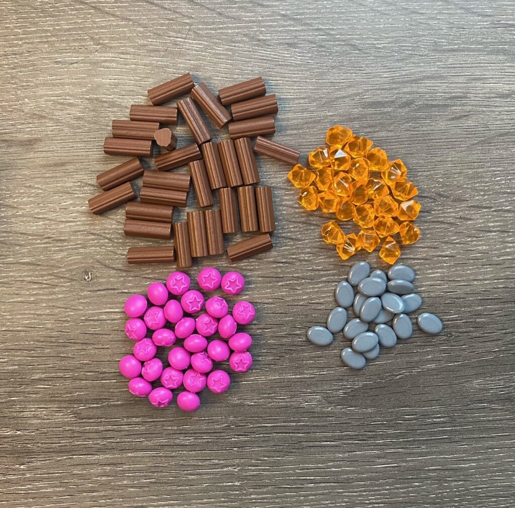 resource tokens representing wood, resin, stones and berries. 