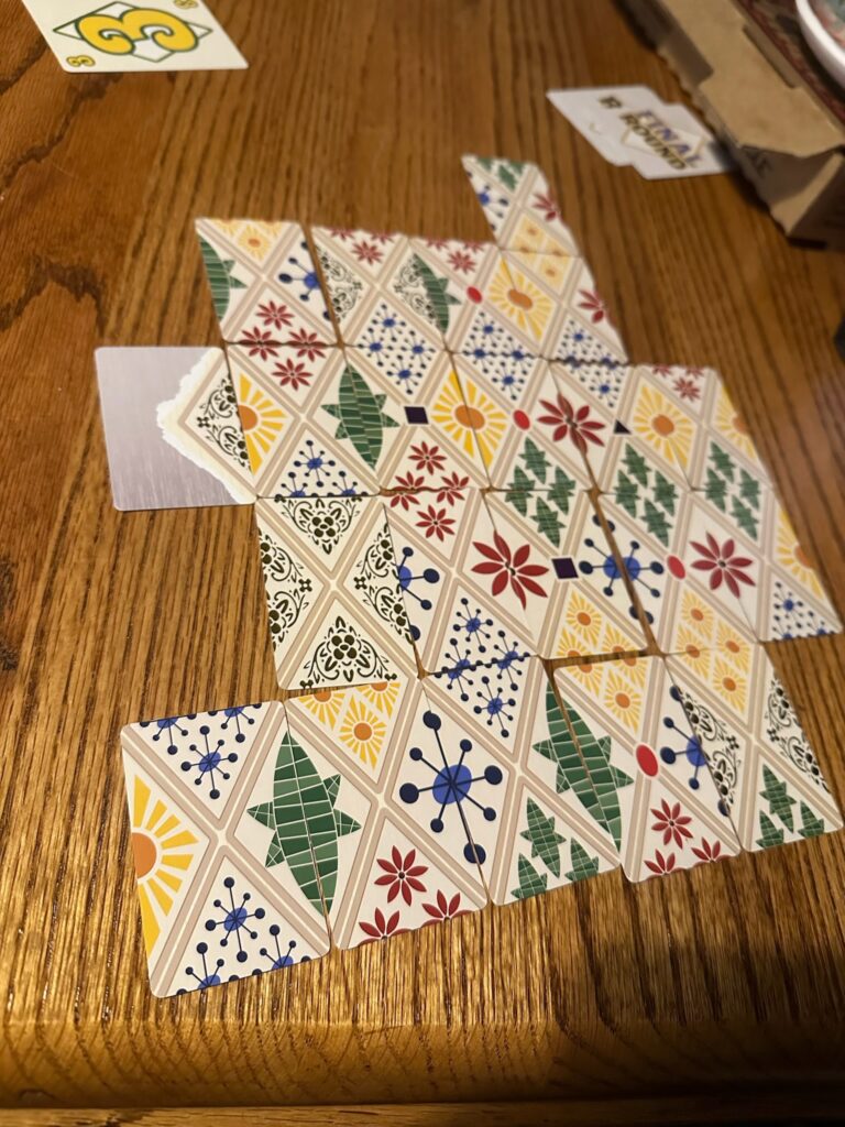 Card lay together on a wooden surface, creating diamond shaped designs between cards.