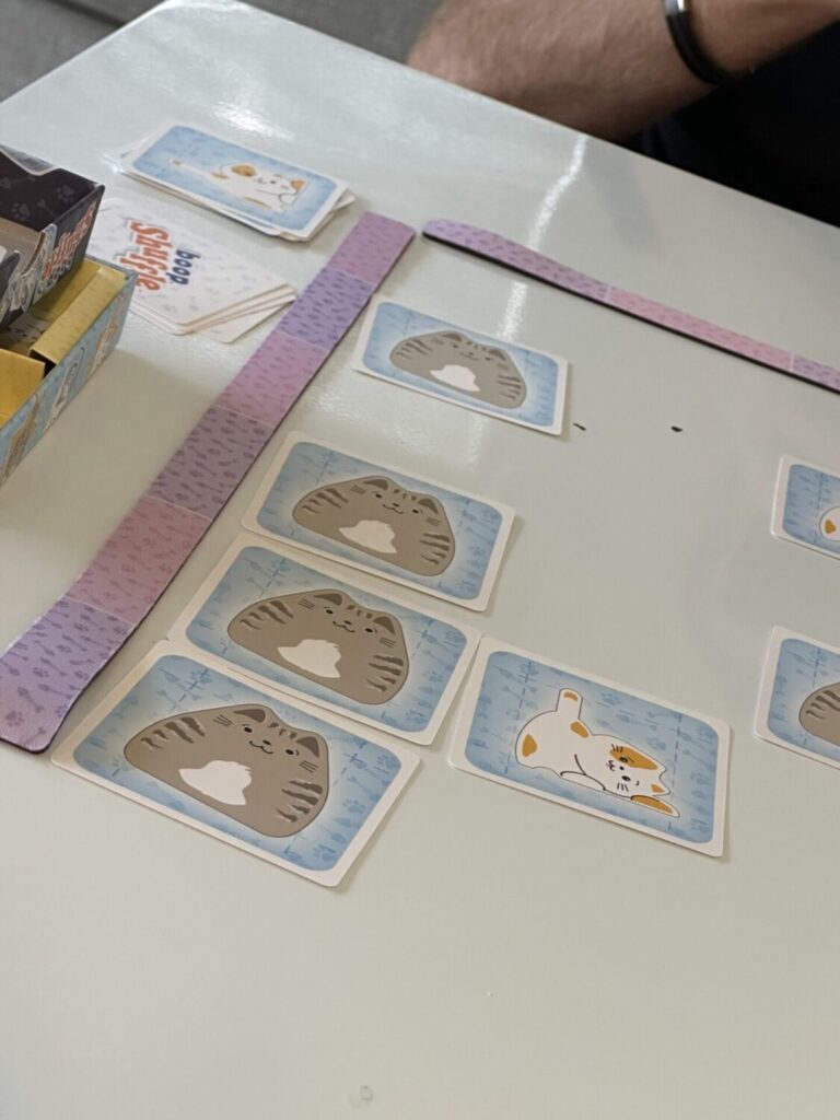 within the boop shuffle playing area, three gray cats are shown in a row.