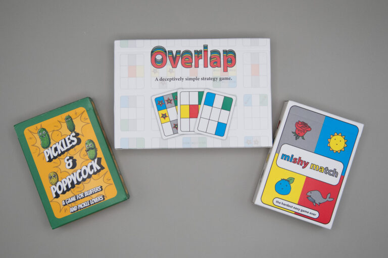 Three card boxes read, front left to right, Pickles & Poppycock, Overlap and mishy match.